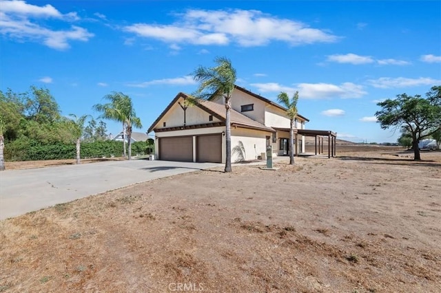 29801 Maxine Ln, Menifee, CA 92584 - view of property exterior with driveway, a garage, and stucco siding