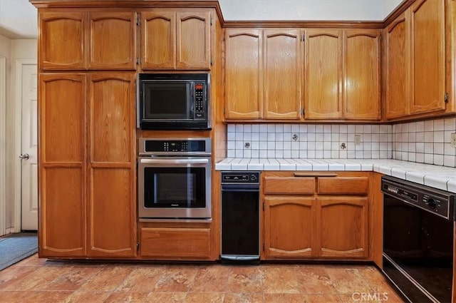 29801 Maxine Ln, Menifee, CA 92584 - kitchen featuring black appliances, backsplash, tile counters, and brown cabinets