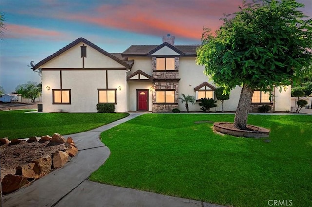 29801 Maxine Ln, Menifee, CA 92584 - tudor house with a front yard, a chimney, stucco siding, and stone siding