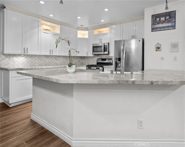 3611 S Bear St Unit D, Santa Ana, CA 92704 - kitchen featuring appliances with stainless steel finishes, decorative backsplash, white cabinetry, dark wood finished floors, and light stone counters