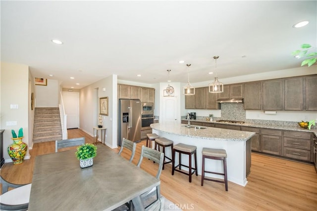 11534 Alana Ln, Beaumont, CA 92223 - dining room with recessed lighting, stairway, and light wood-style floors