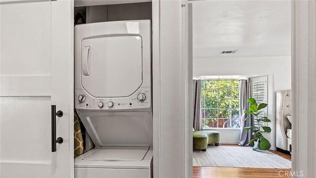 3209 Bennett Dr, Los Angeles, CA 90068 - washroom with stacked washing machine and dryer and wood finished floors