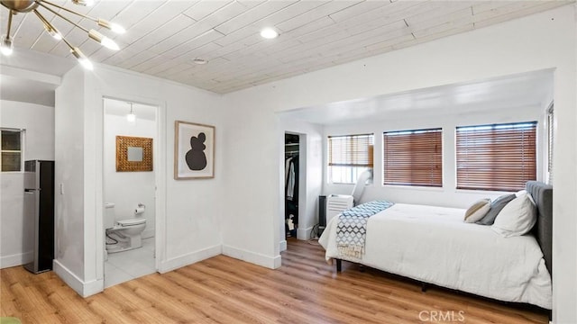 3209 Bennett Dr, Los Angeles, CA 90068 - bedroom featuring light wood finished floors, freestanding refrigerator, a spacious closet, a closet, and a chandelier