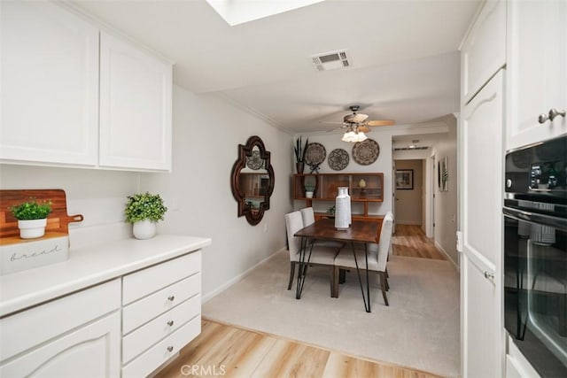 933 Avenida Majorca Unit P, Laguna Woods, CA 92637 - dining area with a ceiling fan, light wood finished floors, and ornamental molding