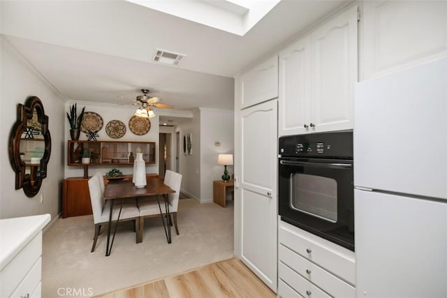 933 Avenida Majorca Unit P, Laguna Woods, CA 92637 - kitchen featuring freestanding refrigerator, oven, white cabinets, ornamental molding, and a ceiling fan