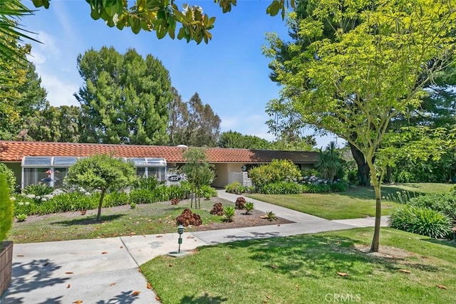 933 Avenida Majorca Unit P, Laguna Woods, CA 92637 - view of front facade with a tile roof and a front yard