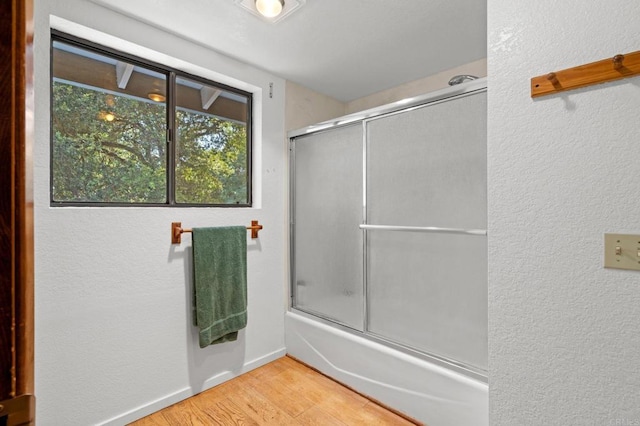5041 Pine Ridge Ave, Julian, CA 92036 - full bathroom featuring combined bath / shower with glass door, wood finished floors, and a textured wall