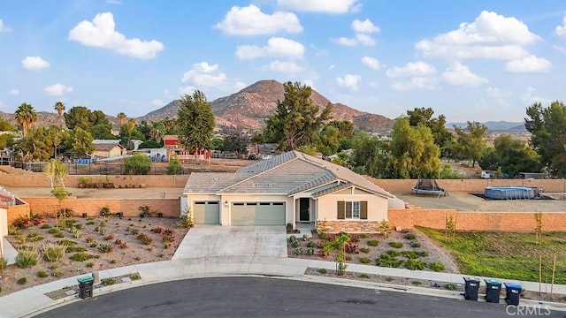 30701 Noble Ct, Homeland, CA 92548 - ranch-style home featuring a garage, a mountain view, driveway, and stucco siding