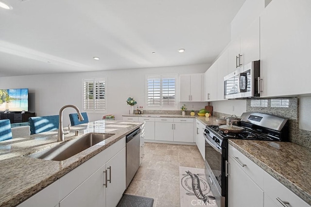 30701 Noble Ct, Homeland, CA 92548 - kitchen featuring stainless steel appliances, light stone countertops, white cabinets, and recessed lighting