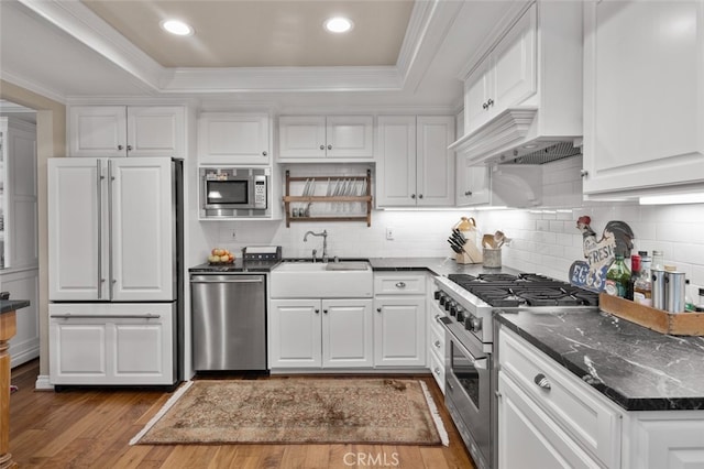 21761 Tahoe Ln, Lake Forest, CA 92630 - kitchen featuring built in appliances, a raised ceiling, wood finished floors, white cabinets, and tasteful backsplash