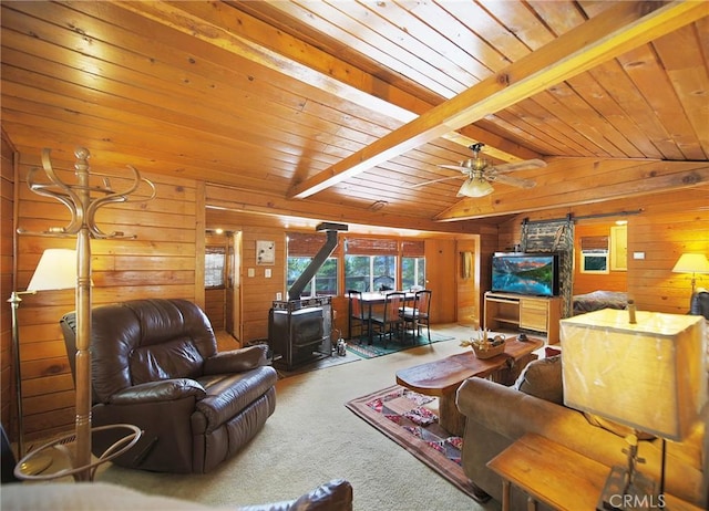 22052 Elliot Rd, Cedarpines Park, CA 92322 - carpeted living room featuring a wood stove, wooden walls, ceiling fan, and wood ceiling