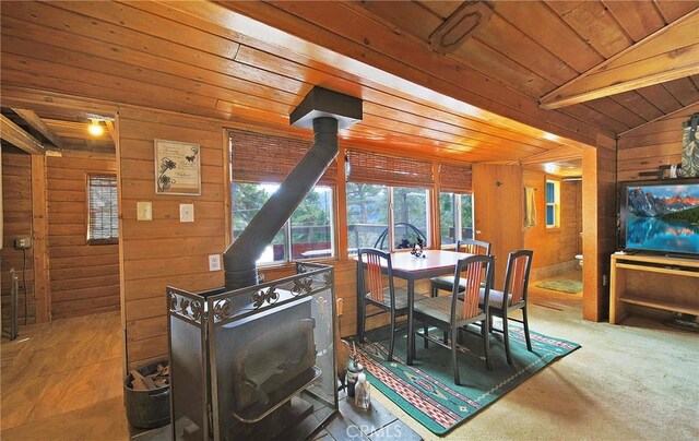 22052 Elliot Rd, Cedarpines Park, CA 92322 - dining space with a wood stove, wood walls, wooden ceiling, and lofted ceiling