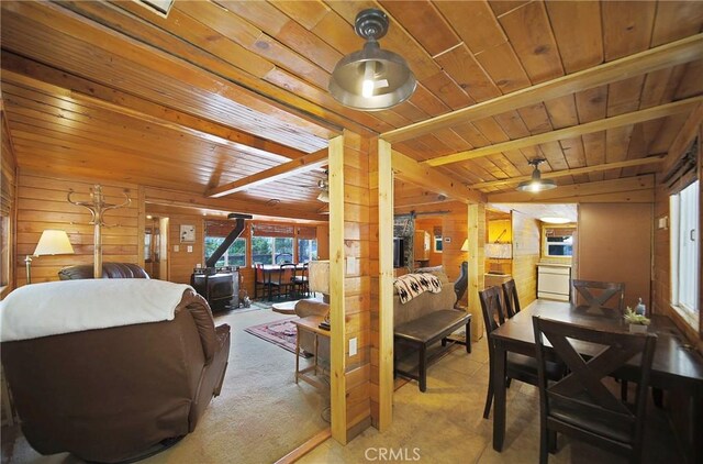 22052 Elliot Rd, Cedarpines Park, CA 92322 - dining area with a wooden ceiling with exposed beams, wood walls, and a wood stove