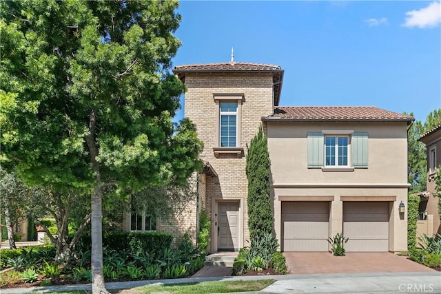32 Tesoro, Irvine, CA 92618 - view of front of property with a tile roof, an attached garage, decorative driveway, and stucco siding