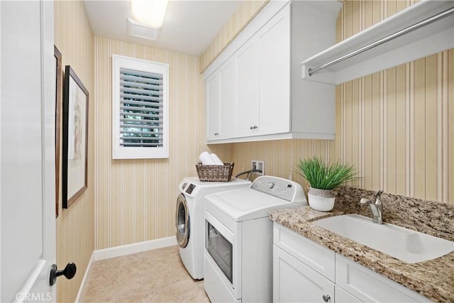 32 Tesoro, Irvine, CA 92618 - washroom featuring washing machine and clothes dryer, wallpapered walls, cabinet space, and light tile patterned flooring