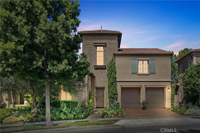 32 Tesoro, Irvine, CA 92618 - view of front of property with a tile roof, a garage, driveway, and stucco siding