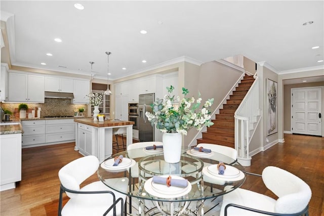 32 Tesoro, Irvine, CA 92618 - dining room with wood finished floors, crown molding, stairs, and recessed lighting