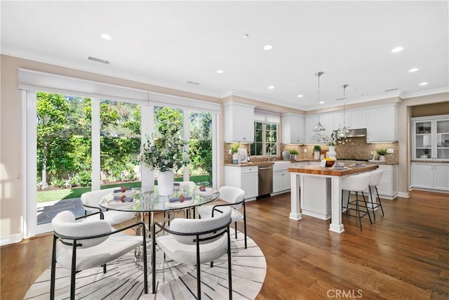 32 Tesoro, Irvine, CA 92618 - dining area with crown molding, recessed lighting, and dark wood-style flooring