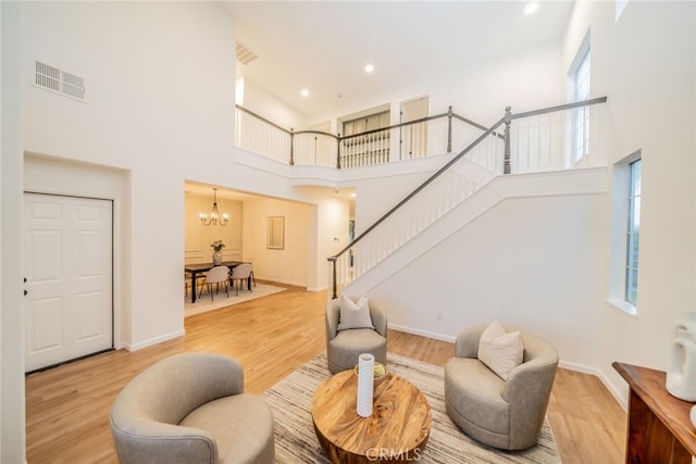 2455 Mcmackin Dr, Corona, CA 92881 - living room featuring a high ceiling, stairs, plenty of natural light, light wood-type flooring, and recessed lighting