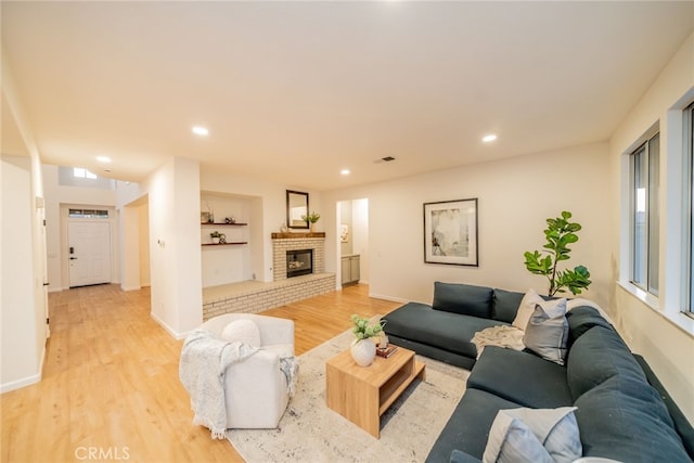 2455 Mcmackin Dr, Corona, CA 92881 - living room with light wood-style flooring, recessed lighting, a fireplace, and built in features