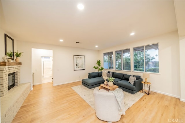 2455 Mcmackin Dr, Corona, CA 92881 - living room with light wood-type flooring, recessed lighting, and a brick fireplace