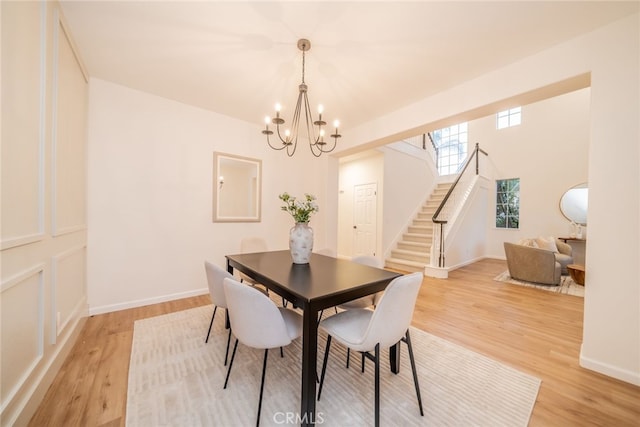 2455 Mcmackin Dr, Corona, CA 92881 - dining space featuring a chandelier, stairs, and light wood finished floors