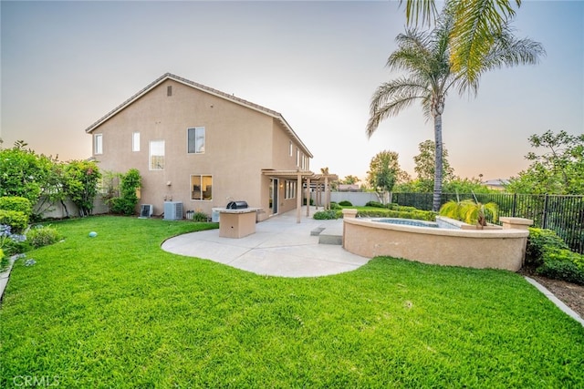 2455 Mcmackin Dr, Corona, CA 92881 - back of property at dusk with a fenced backyard, stucco siding, and a patio
