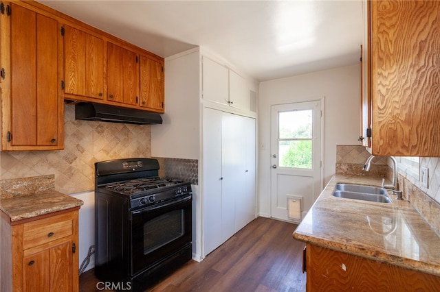 10935 Nassau Ave, Sunland, CA 91040 - kitchen featuring black gas range oven, under cabinet range hood, dark wood-style flooring, decorative backsplash, and brown cabinets