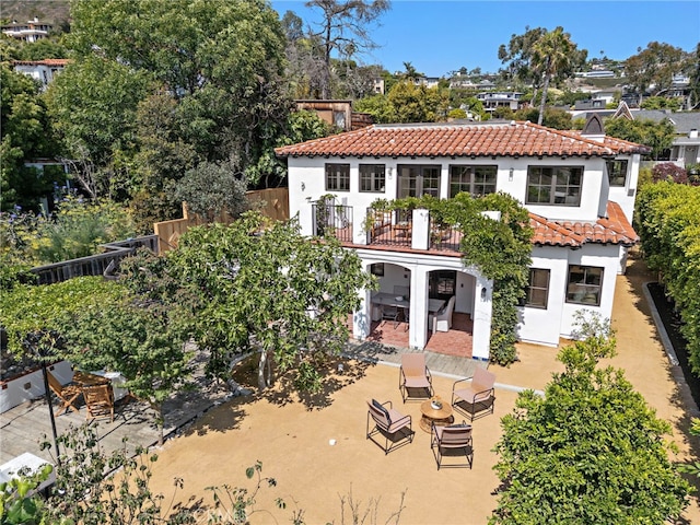 750 Manzanita Dr, Laguna Beach, CA 92651 - back of house featuring a tile roof, stucco siding, a patio, and a balcony