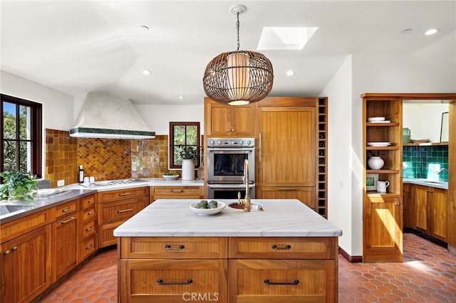 750 Manzanita Dr, Laguna Beach, CA 92651 - kitchen with range hood, double oven, a skylight, decorative backsplash, and stovetop
