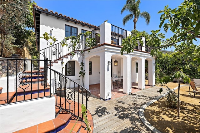 750 Manzanita Dr, Laguna Beach, CA 92651 - rear view of property with stucco siding, a patio, a balcony, and stairs