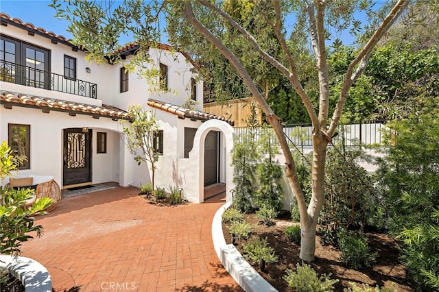 750 Manzanita Dr, Laguna Beach, CA 92651 - mediterranean / spanish-style house with stucco siding, a tile roof, a patio, and a balcony
