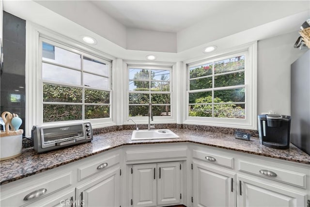 1733 Bayou Way, Seal Beach, CA 90740 - kitchen with white cabinets, dark stone counters, and recessed lighting