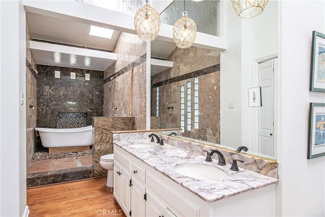 1733 Bayou Way, Seal Beach, CA 90740 - full bath featuring double vanity, a soaking tub, wood finished floors, and tiled shower