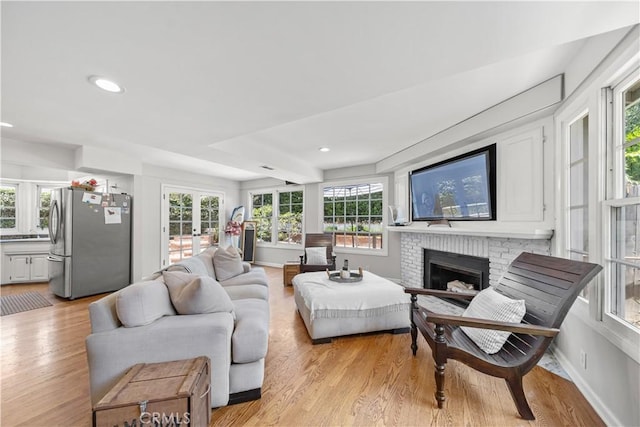 1733 Bayou Way, Seal Beach, CA 90740 - living area featuring a brick fireplace, light wood-type flooring, recessed lighting, and french doors