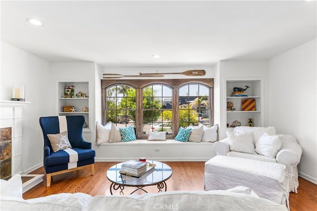 1733 Bayou Way, Seal Beach, CA 90740 - living area with built in shelves, wood finished floors, a tile fireplace, and recessed lighting