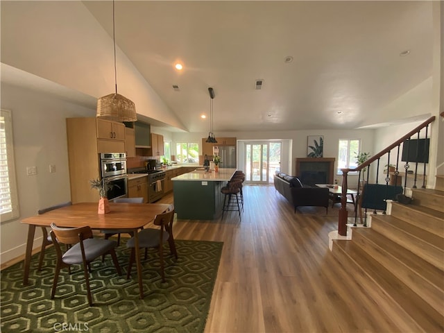 2304 Trickling Creek Dr, La Verne, CA 91750 - dining room with dark wood finished floors, stairs, a fireplace, high vaulted ceiling, and recessed lighting