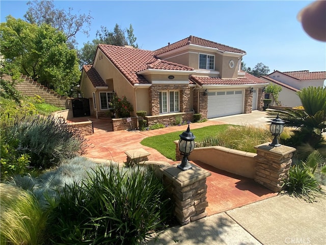 2304 Trickling Creek Dr, La Verne, CA 91750 - mediterranean / spanish home featuring stucco siding, a tile roof, concrete driveway, and stone siding