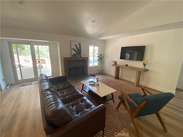 2304 Trickling Creek Dr, La Verne, CA 91750 - living area with lofted ceiling, light wood-style flooring, and a fireplace with flush hearth