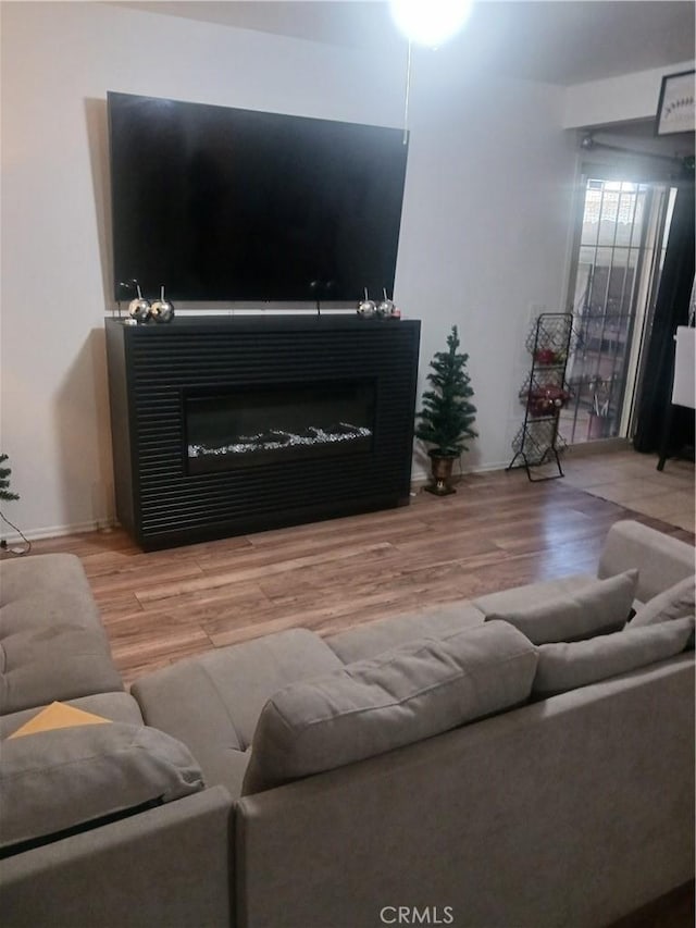 12218 Orchid Ln Unit A, Moreno Valley, CA 92557 - living room with wood finished floors and a glass covered fireplace