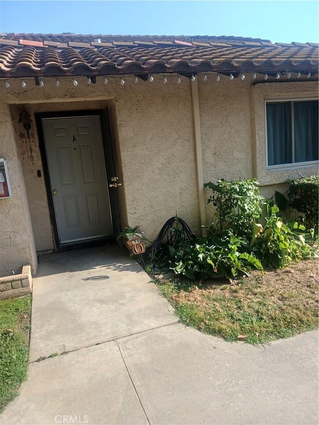 12218 Orchid Ln Unit A, Moreno Valley, CA 92557 - doorway to property with stucco siding