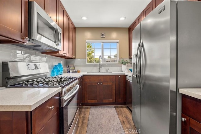 199 N Magnolia Ave Unit D, Anaheim, CA 92801 - kitchen featuring appliances with stainless steel finishes, wood finished floors, decorative backsplash, and recessed lighting
