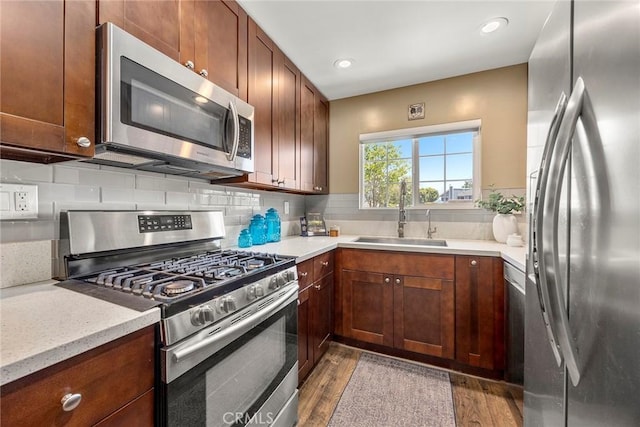 199 N Magnolia Ave Unit D, Anaheim, CA 92801 - kitchen featuring stainless steel appliances, dark wood-style flooring, decorative backsplash, and recessed lighting