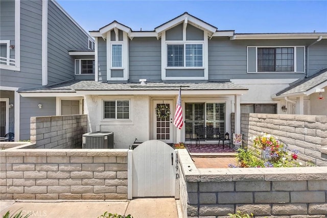 199 N Magnolia Ave Unit D, Anaheim, CA 92801 - townhome / multi-family property with a fenced front yard, a gate, and roof with shingles