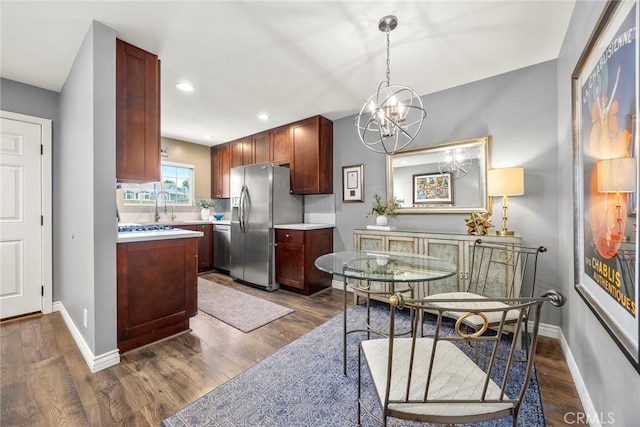 199 N Magnolia Ave Unit D, Anaheim, CA 92801 - kitchen with appliances with stainless steel finishes, light countertops, dark wood finished floors, and recessed lighting