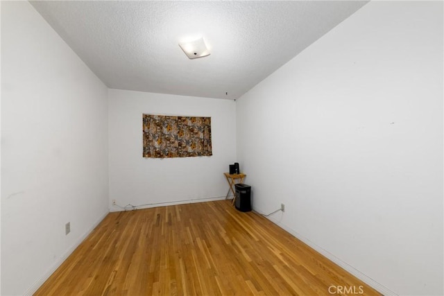 5064 N Berkeley Ave, San Bernardino, CA 92407 - empty room with light wood-style flooring and a textured ceiling