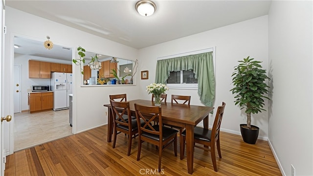 5064 N Berkeley Ave, San Bernardino, CA 92407 - dining space featuring baseboards and light wood-type flooring