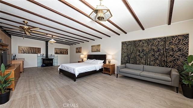 5064 N Berkeley Ave, San Bernardino, CA 92407 - bedroom featuring beamed ceiling, a wood stove, and light wood-style flooring