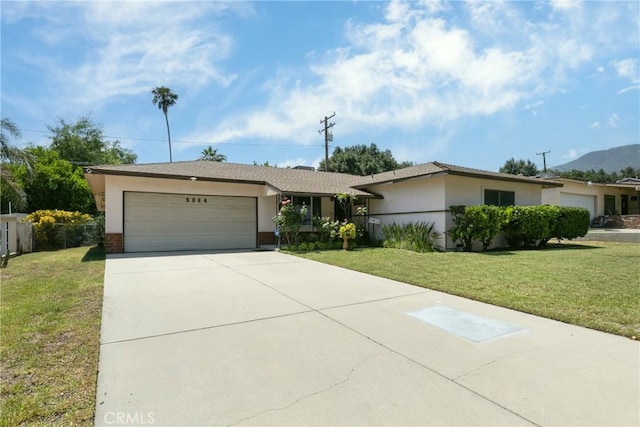 5064 N Berkeley Ave, San Bernardino, CA 92407 - ranch-style house featuring a front yard, an attached garage, concrete driveway, and a mountain view