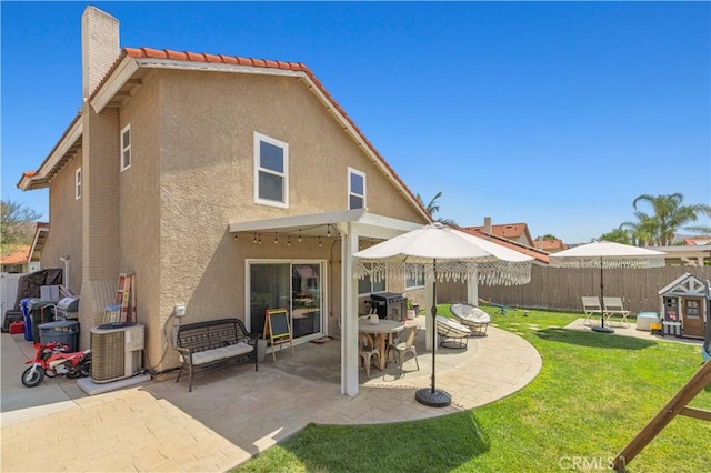 28032 Nantucket St, Castaic, CA 91384 - back of property with stucco siding, a fenced backyard, a chimney, a patio, and a tile roof